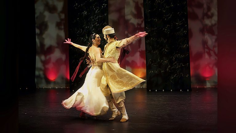 Couple in traditional costumes dancing on stage, Tirgan 2013