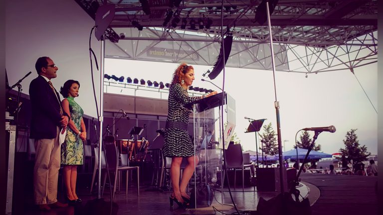 Speaker at a podium on the outdoor stage, Tirgan 2013